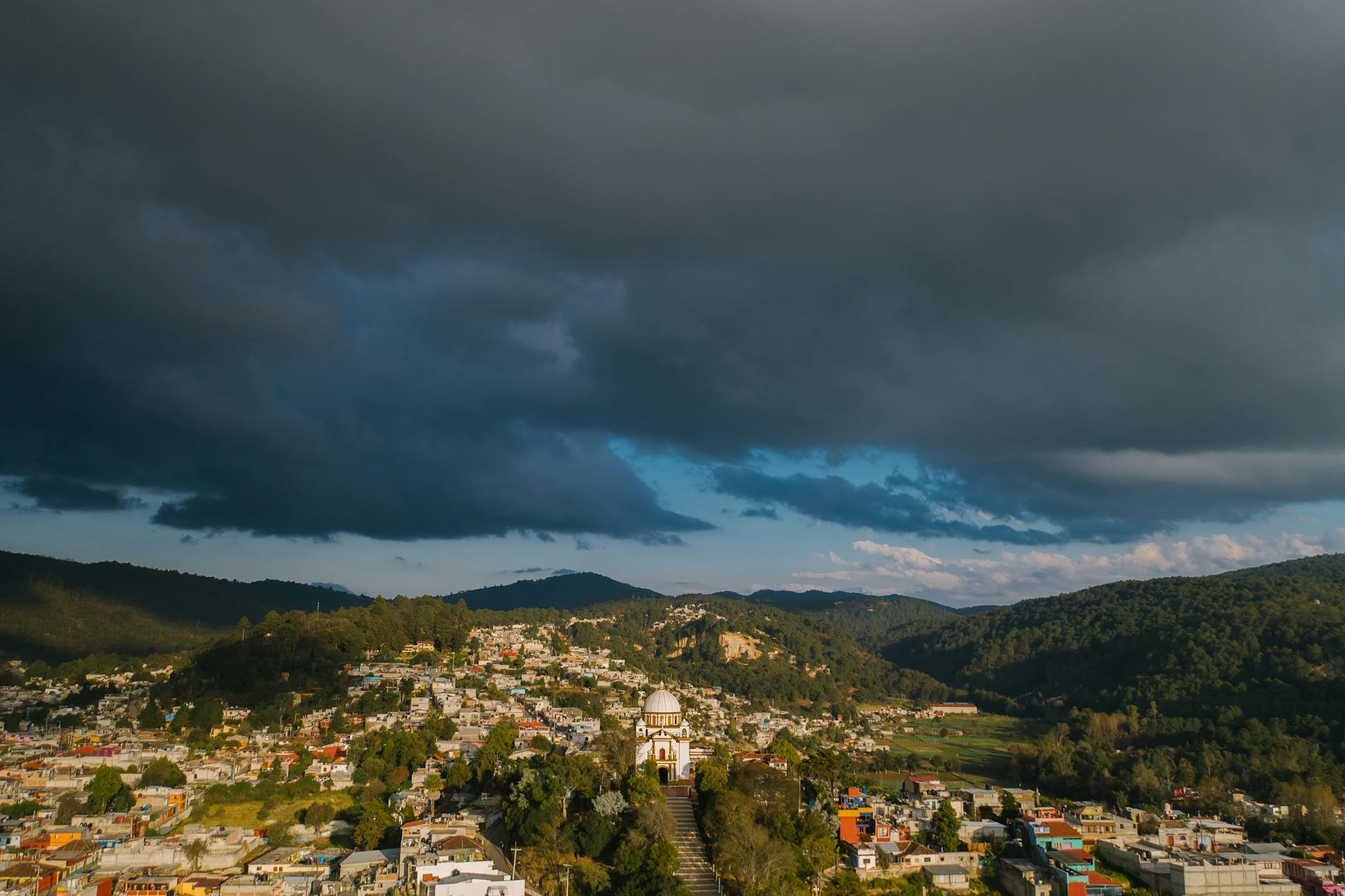 Stunning aerial view of San Cristóbal de las Casas, Mexico with dramatic sky.