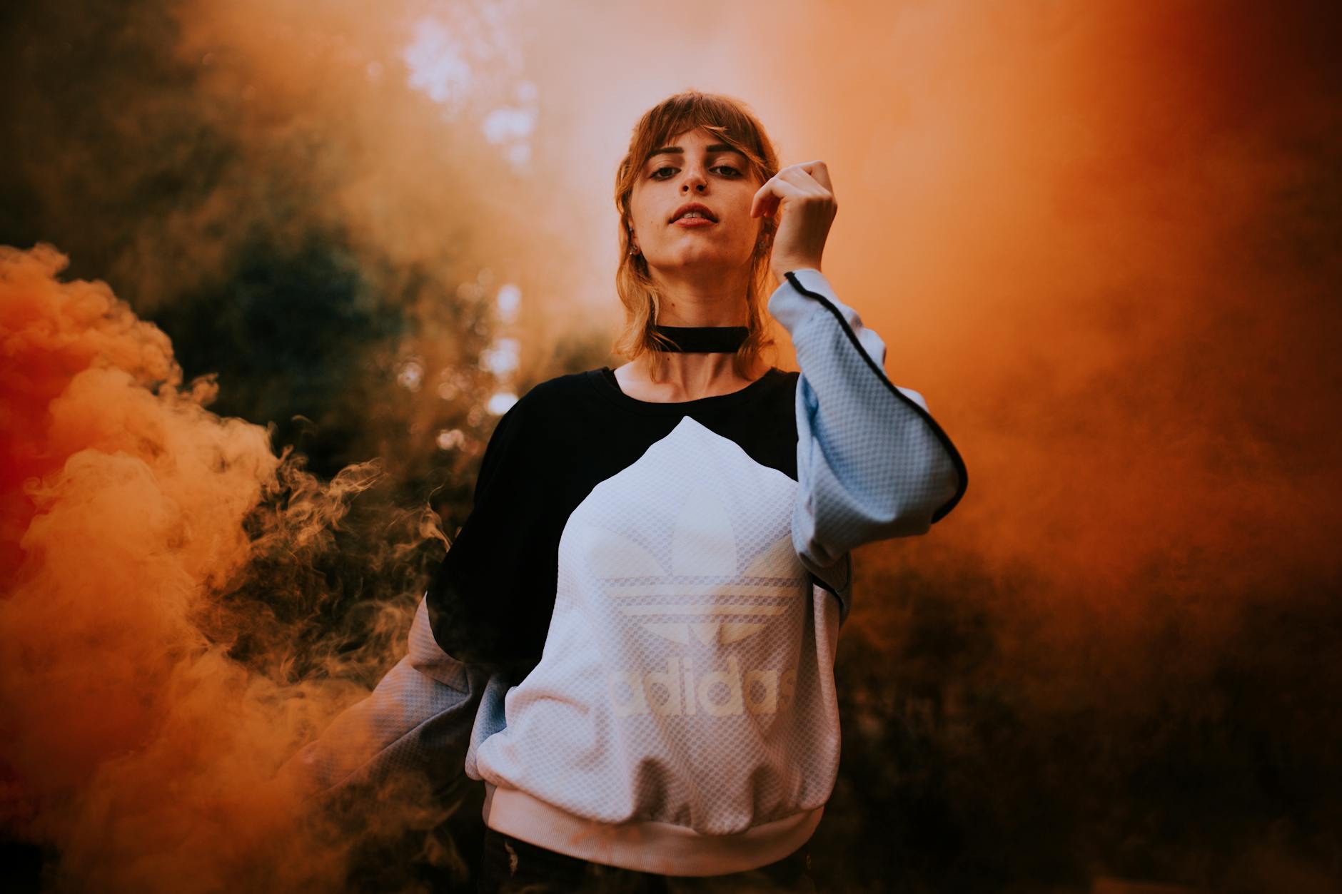 Artistic portrait of a woman with smoke creating a dramatic atmosphere.