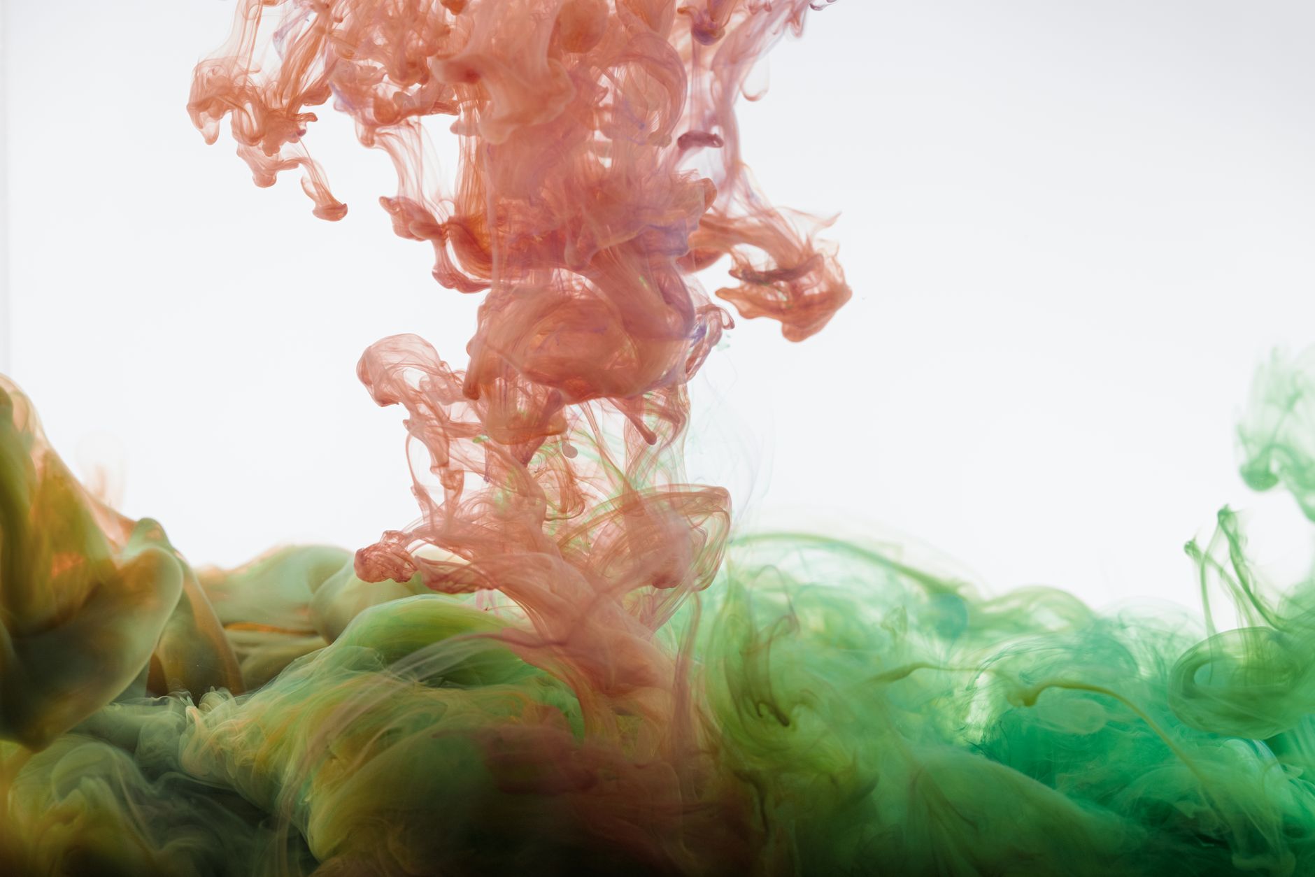 Colorful ink swirling in water creating abstract, fluid patterns with a dynamic motion effect.