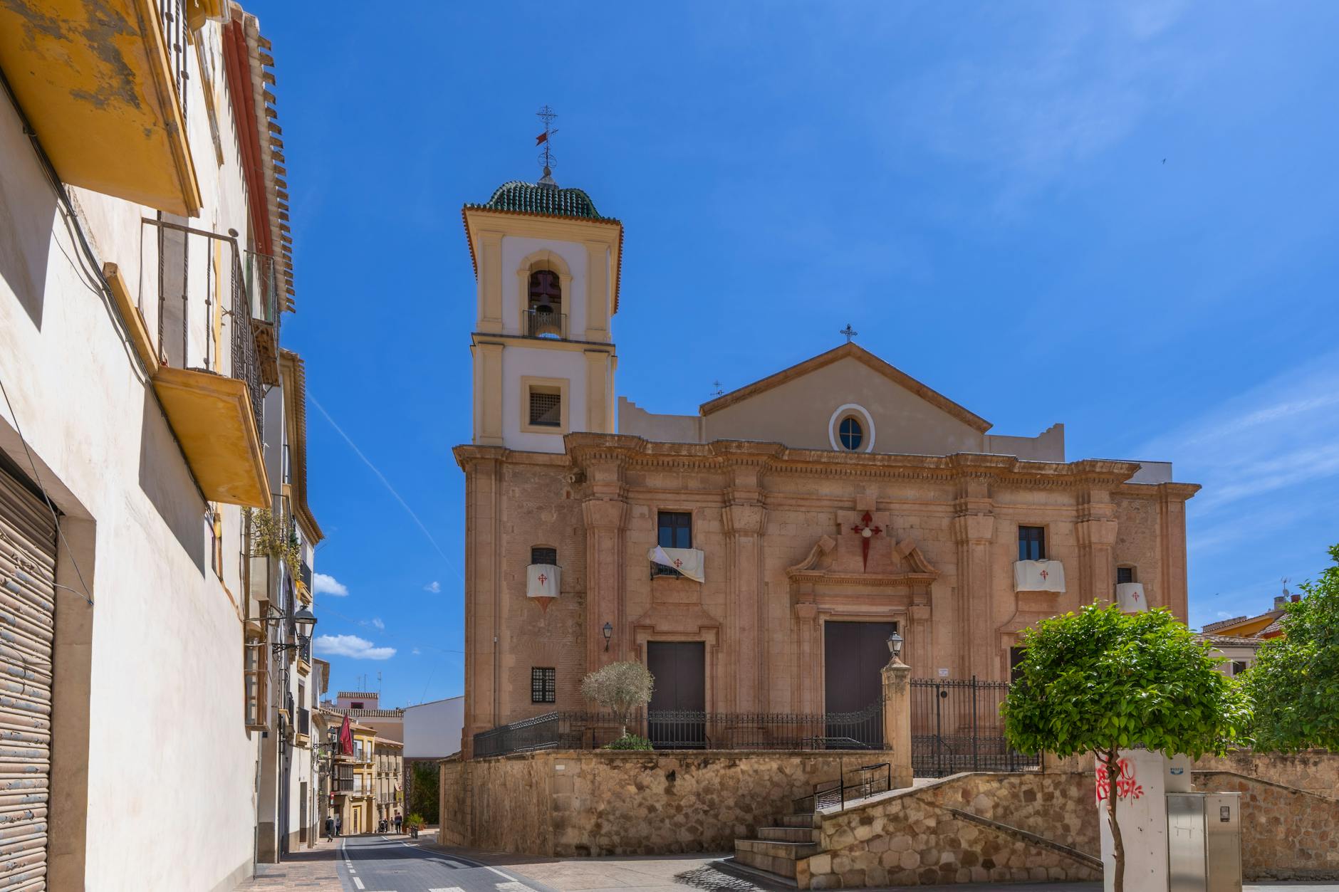 Sunlit view of a historic church in Lorca, Spain, showcasing classic architecture.