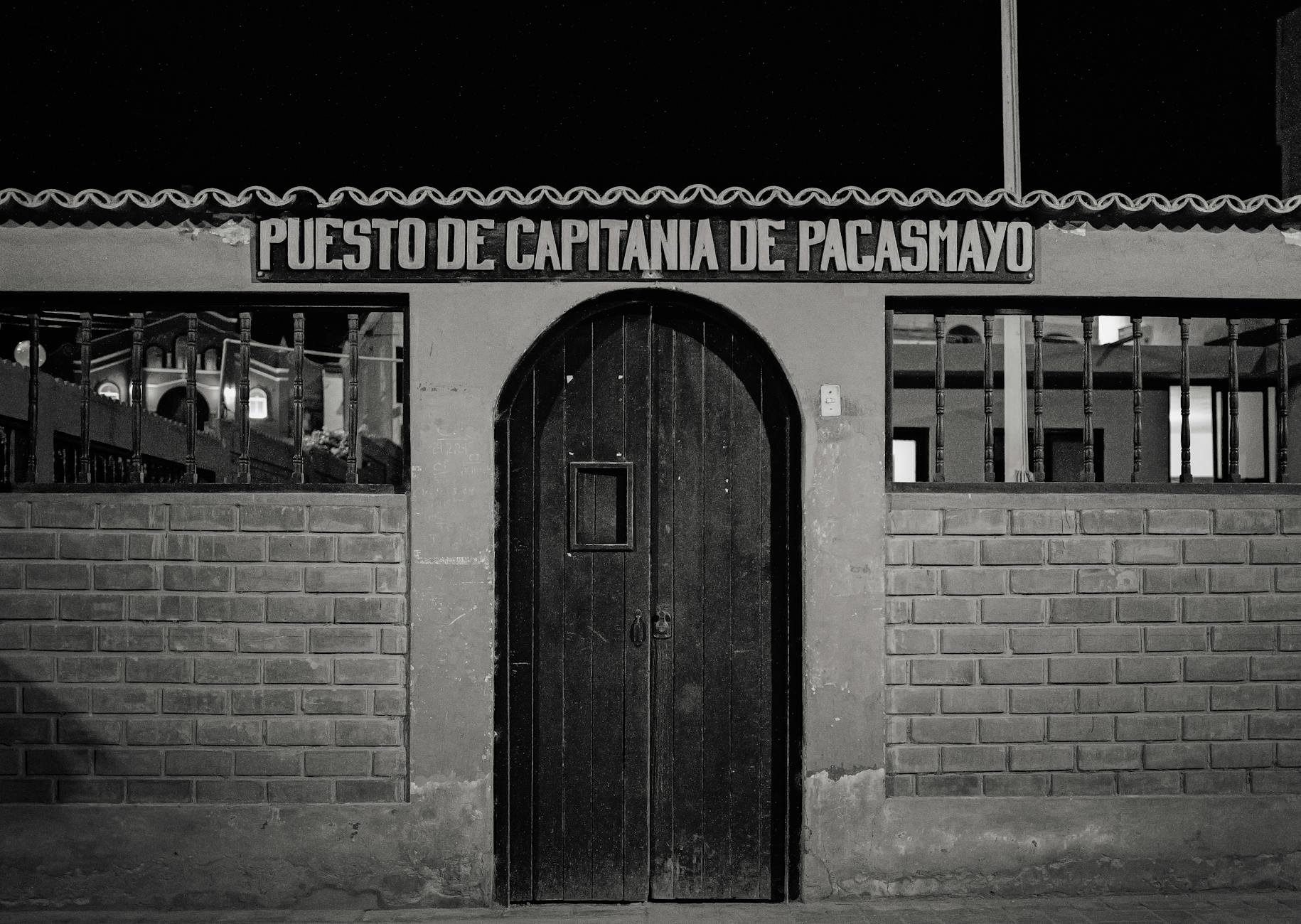 Black and white photo of Puesto De Capitanía de Pacasmayo at night, Peru.