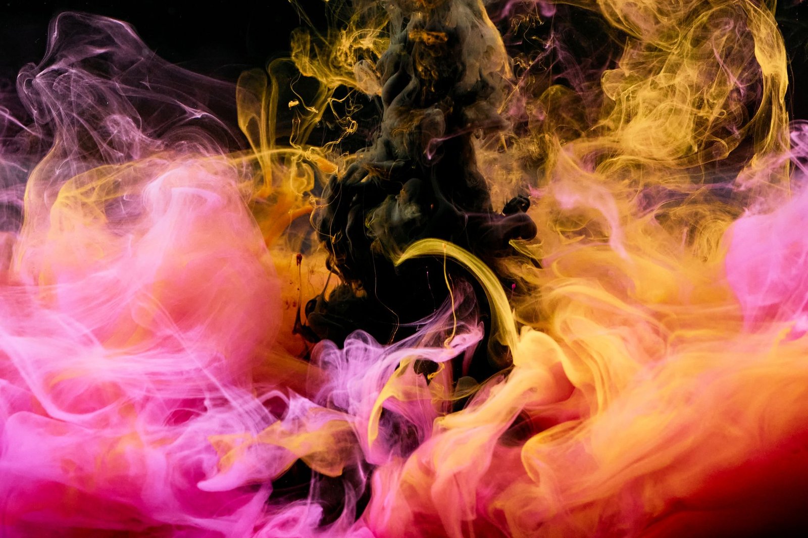 Colorful swirling inks blending in water, creating an abstract visual masterpiece.