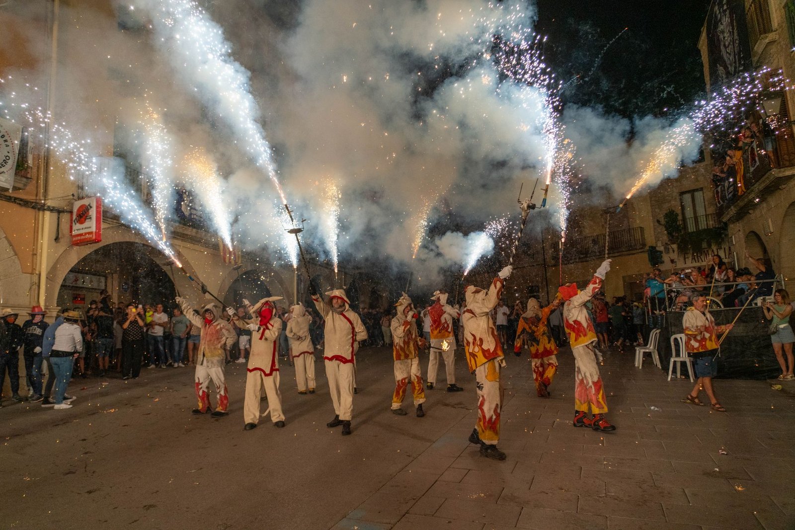 Dramatic night-time correfoc celebration with performers and fireworks in Les Borges Blanques, Cataluña, Spain.