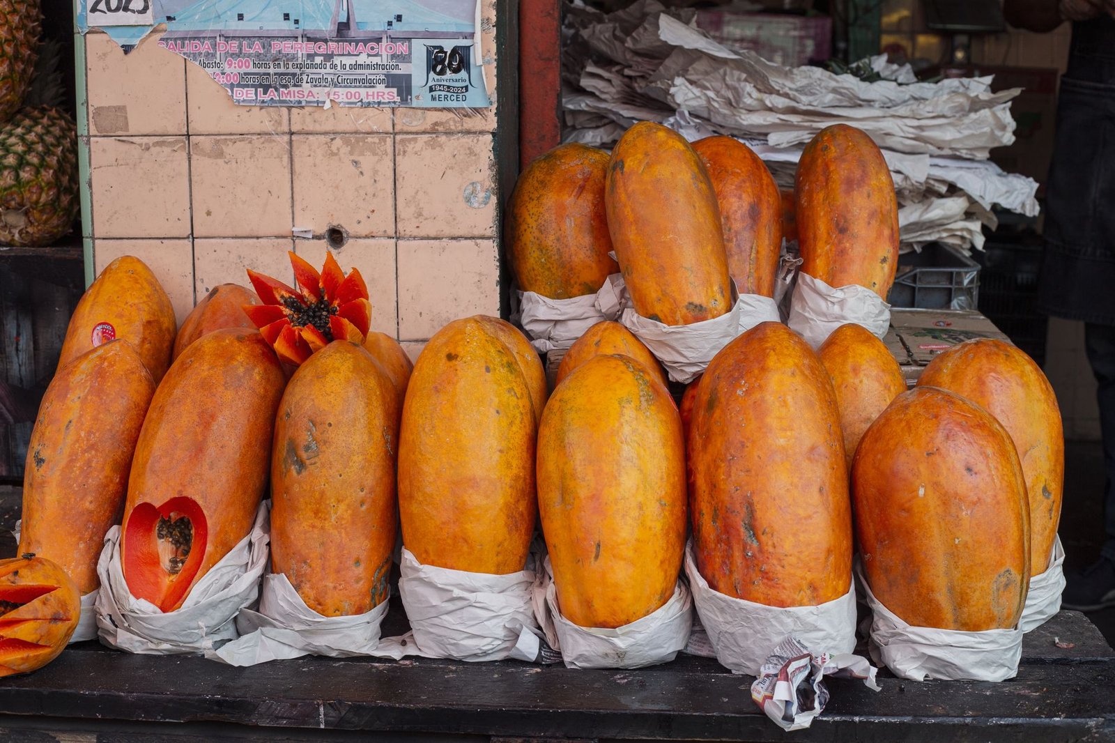 Bright papayas on display at a market stall in Mexico City, showcasing tropical fruit abundance.
