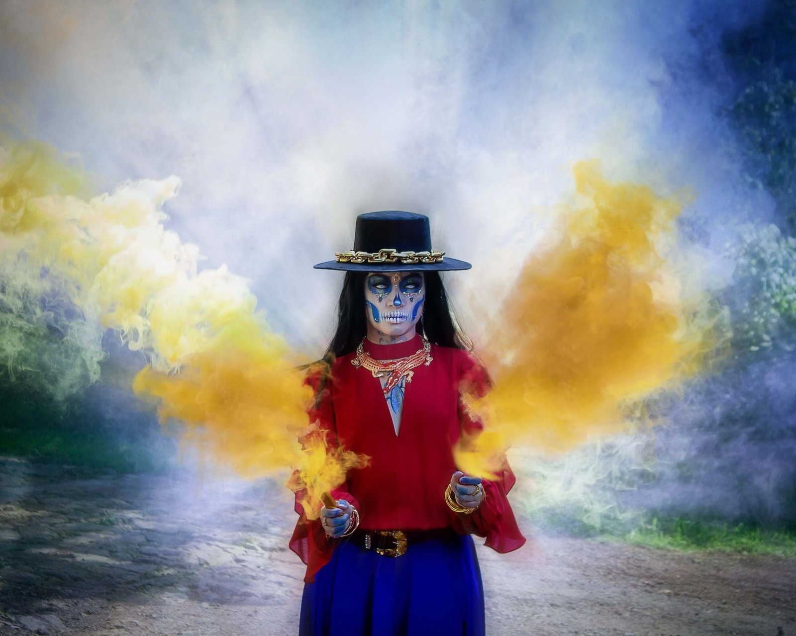 Vibrant Day of the Dead character with smoke, in festive attire outdoors.