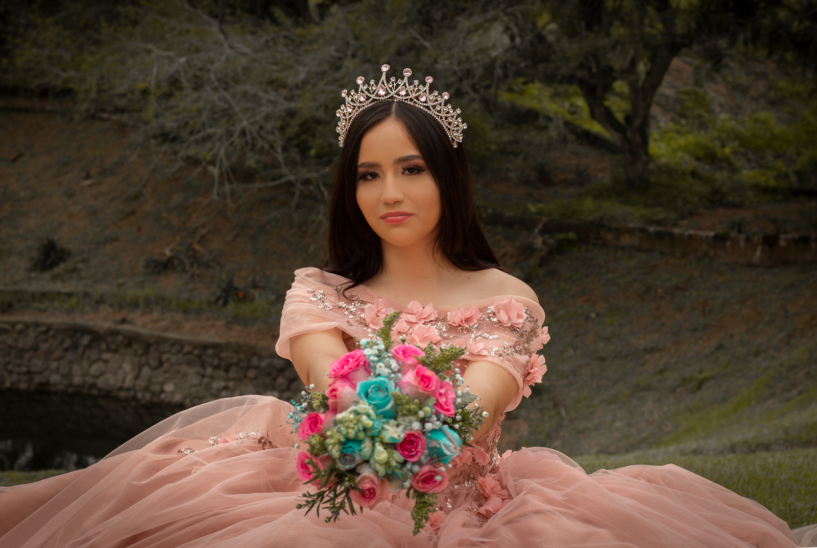 Stunning quinceañera portrait with a floral bouquet and crown in Santo Domingo, Ecuador.