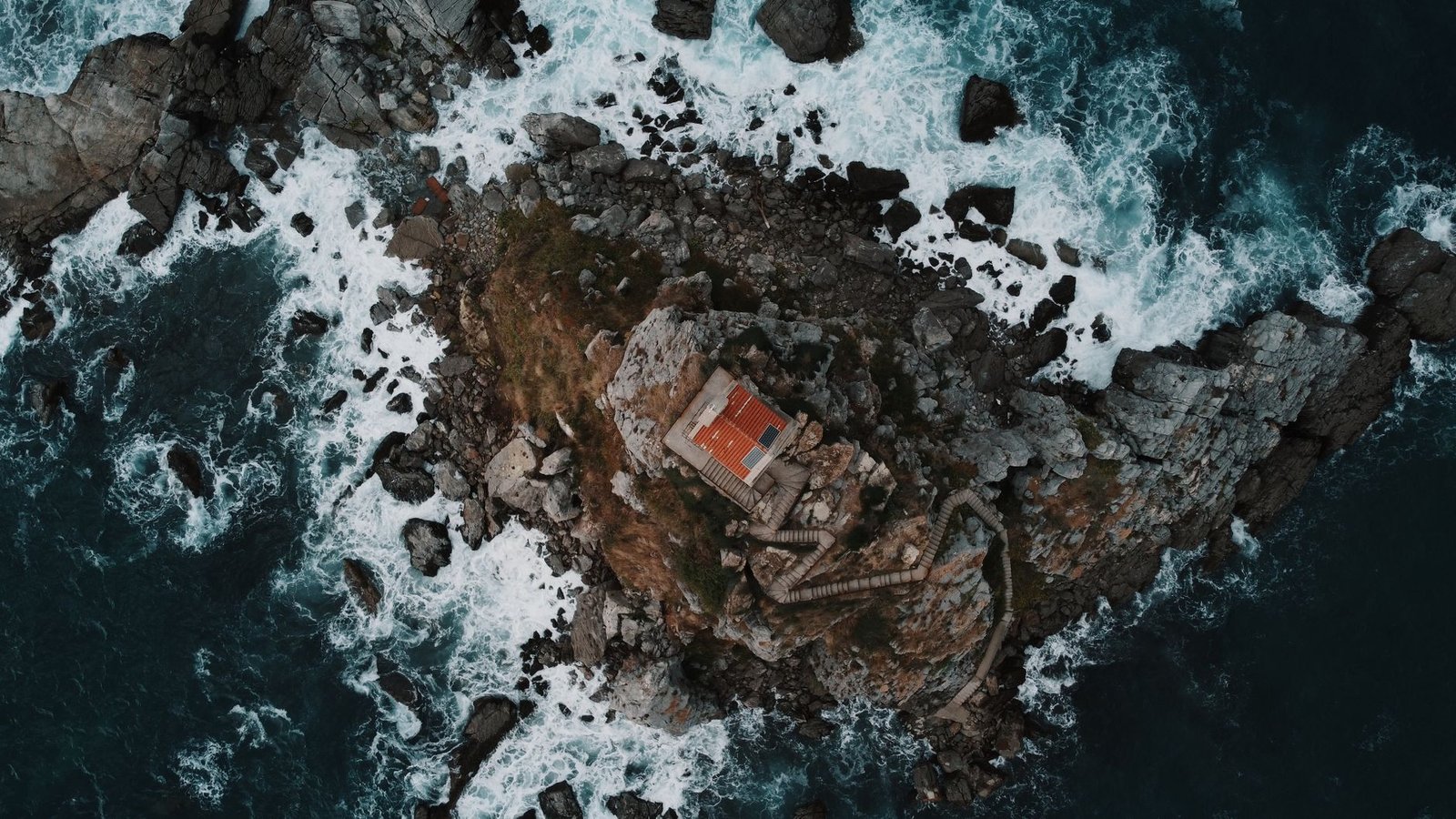 Stunning aerial view of St. Nedjelja Church perched on a rocky outcrop in Petrovac, Montenegro.